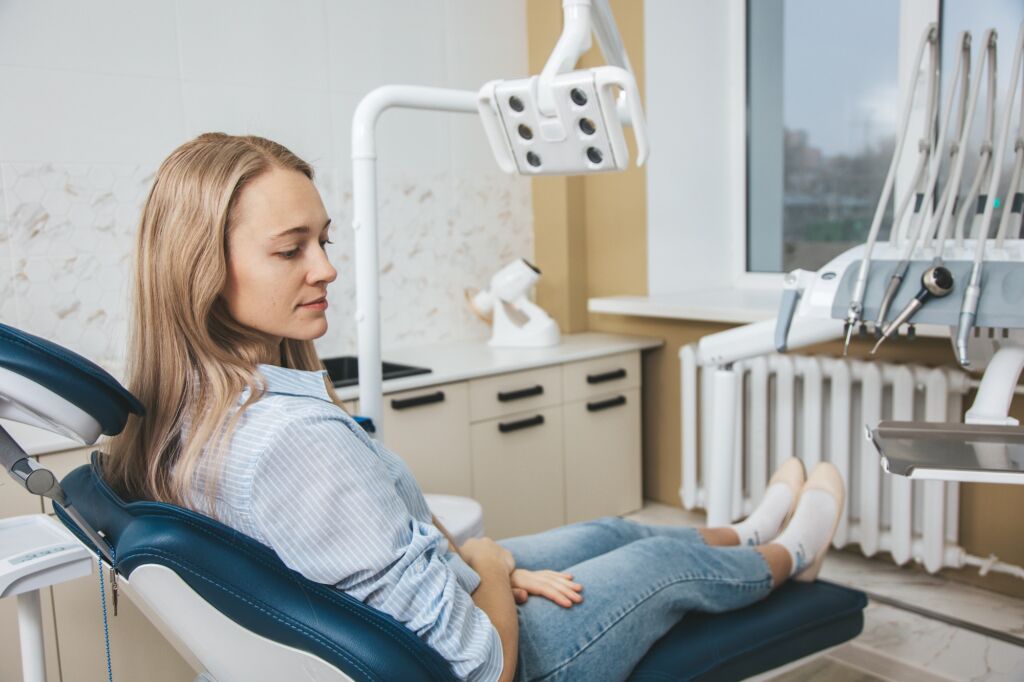 Patient at dentist chair in stomatologic clinic
